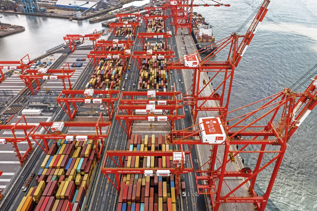 Container terminal with cargo vessels and shipping containers, highlighting MSC supply chain visibility and geofencing technology