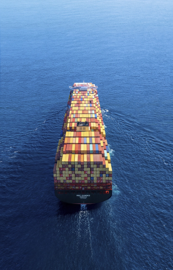 Aerial view of an MSC container ship carrying cargo across an MSC East-West ocean shipping route